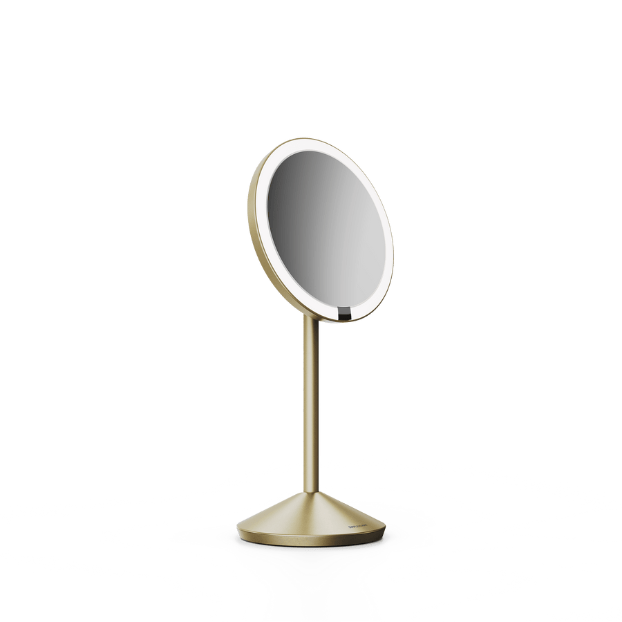 Simplehuman's Sensor Mirror Fold in Matte Gold, angled view.