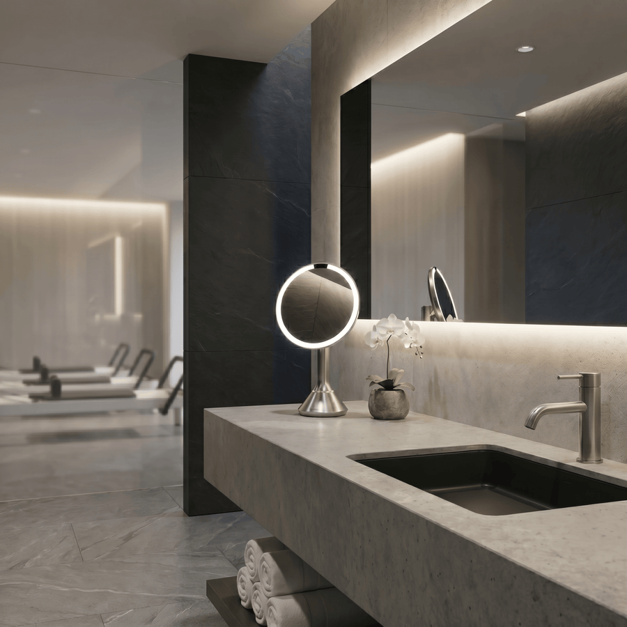 Simplehuman's Sensor Mirror Round in Brushed in a modern pilates studio bathroom setting