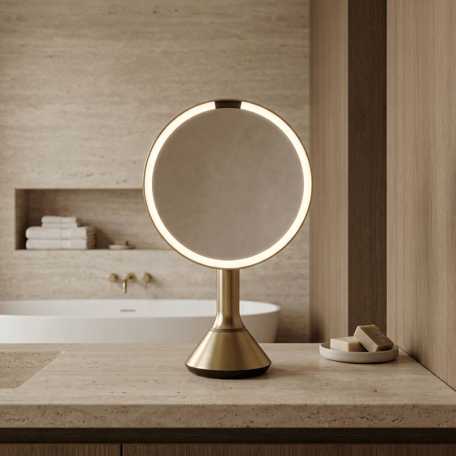 Simplehuman's Sensor Mirror Round in Brass in a modern bathroom setting